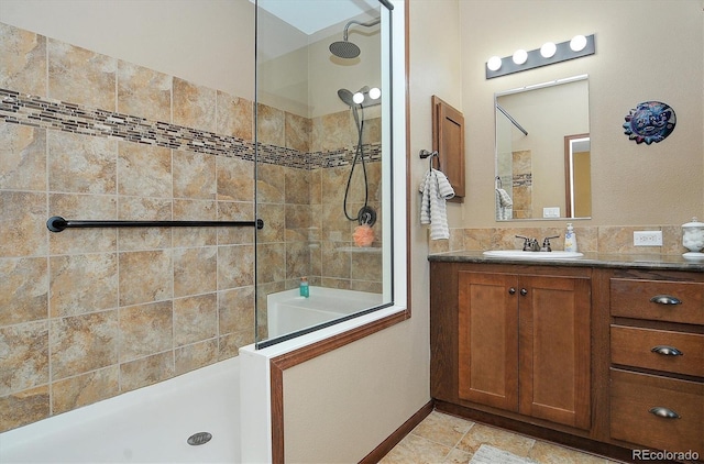 bathroom with vanity and tiled shower