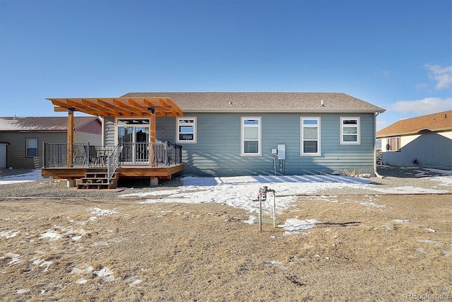 back of property featuring a pergola and a wooden deck