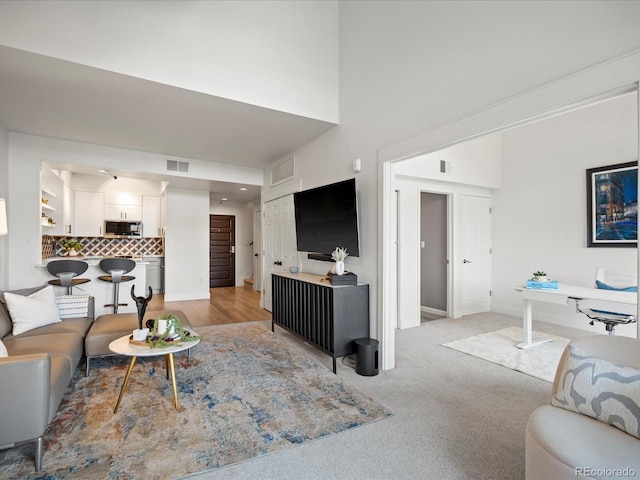 345 Fillmore Unit 407, Denver, CO 80206 - living room featuring a high ceiling and light colored carpet