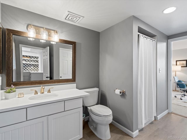 345 Fillmore Unit 407, Denver, CO 80206 - bathroom featuring wood finished floors, vanity, and a shower with shower curtain