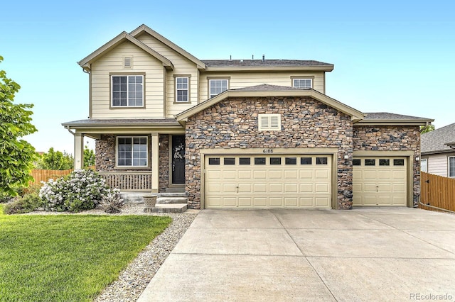 6108 S Harvest Ct, Aurora, CO 80016 - view of front of home featuring stone siding, driveway, a garage, a porch, and roof with shingles