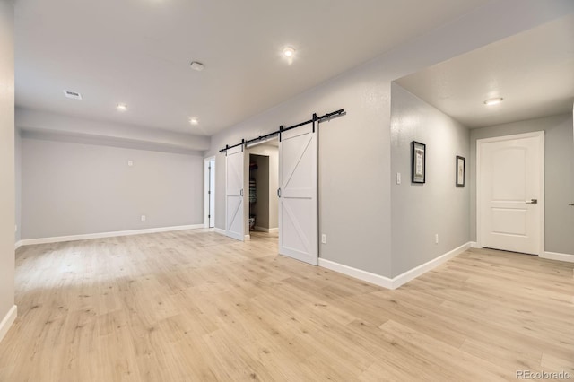 6108 S Harvest Ct, Aurora, CO 80016 - empty room featuring a barn door, light wood-type flooring, baseboards, and recessed lighting