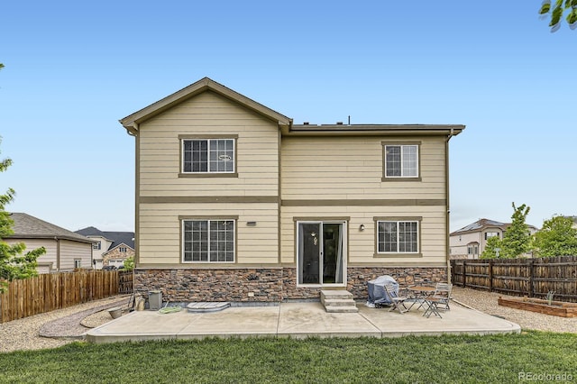 6108 S Harvest Ct, Aurora, CO 80016 - rear view of property with a patio area, stone siding, and entry steps