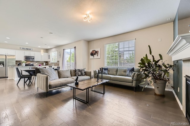 6108 S Harvest Ct, Aurora, CO 80016 - living area featuring hardwood / wood-style floors and recessed lighting