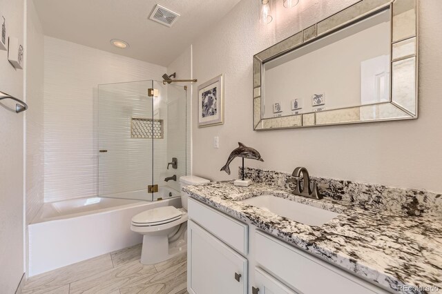 6108 S Harvest Ct, Aurora, CO 80016 - bathroom featuring vanity, shower / bath combination, marble look tiles, and recessed lighting