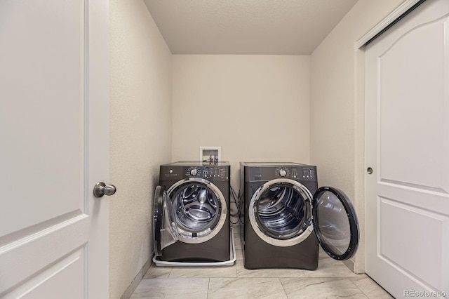 6108 S Harvest Ct, Aurora, CO 80016 - laundry room featuring marble look tile flooring and washer and clothes dryer