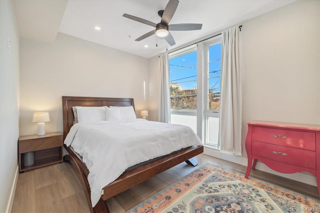 bedroom with light hardwood / wood-style floors and ceiling fan