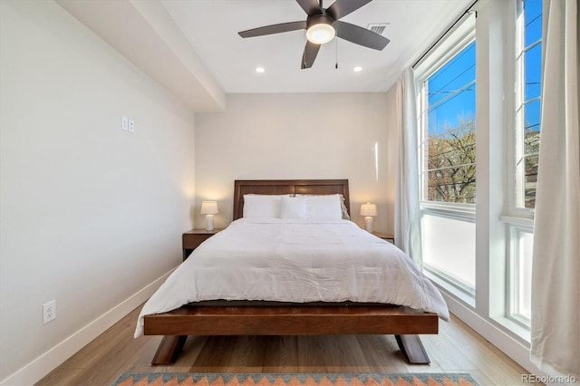 bedroom featuring ceiling fan and light hardwood / wood-style floors