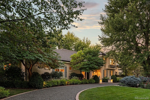 view of front facade featuring a yard and stucco siding