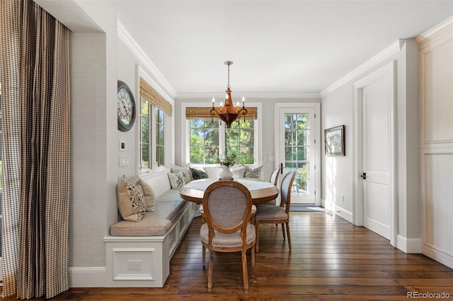 dining area featuring dark wood-type flooring, crown molding, a wealth of natural light, and breakfast area