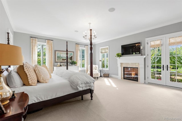 carpeted bedroom with access to exterior, a fireplace with flush hearth, french doors, and crown molding