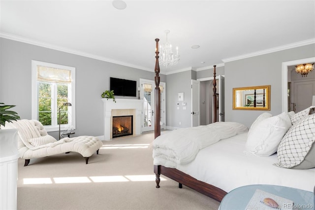 bedroom with a chandelier, light colored carpet, a lit fireplace, and ornamental molding