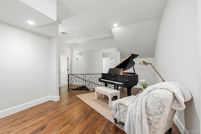 sitting room with visible vents, baseboards, hardwood / wood-style floors, an upstairs landing, and recessed lighting