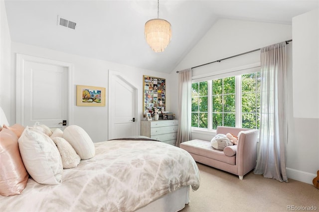 bedroom featuring visible vents, lofted ceiling, and light colored carpet