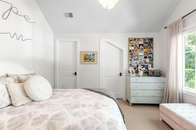 bedroom featuring visible vents, light carpet, multiple windows, and vaulted ceiling