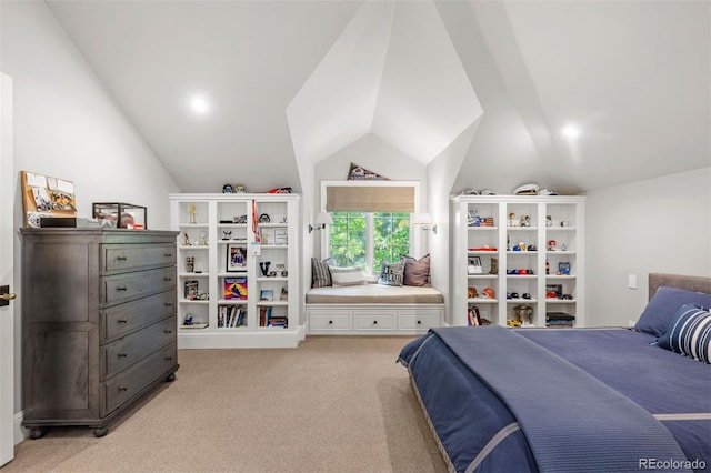 bedroom with light colored carpet and lofted ceiling