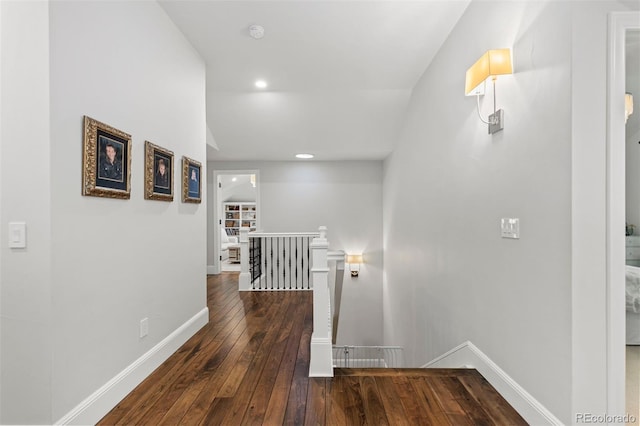 corridor with recessed lighting, baseboards, an upstairs landing, and hardwood / wood-style flooring