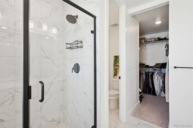 12270 W 57th Ave, Arvada, CO 80002 - bathroom with marble look tiles, a shower stall, toilet, a walk in closet, and baseboards