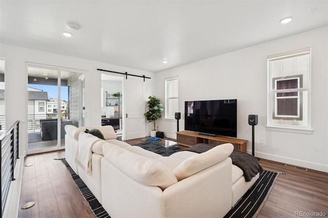 12270 W 57th Ave, Arvada, CO 80002 - living area with a barn door, wood finished floors, baseboards, and recessed lighting