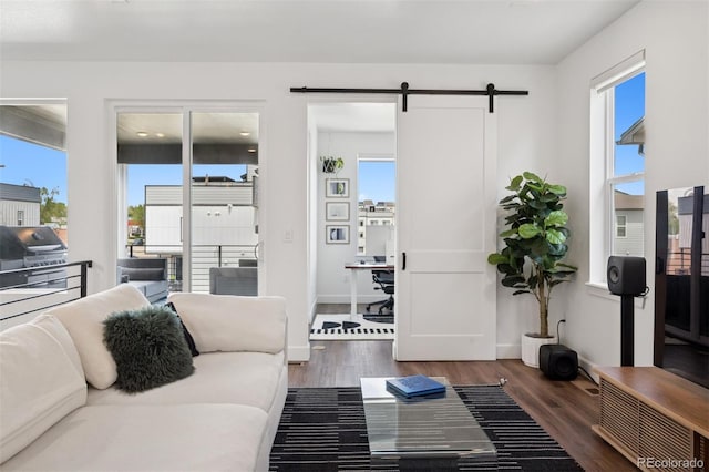 12270 W 57th Ave, Arvada, CO 80002 - living room featuring wood finished floors, a barn door, and baseboards