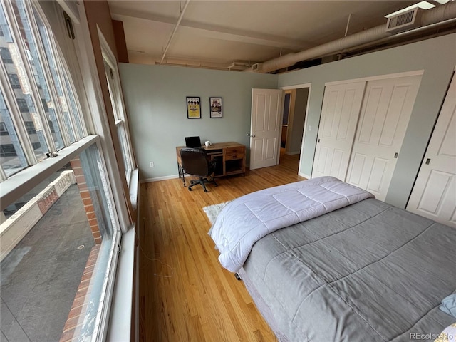 bedroom featuring a closet and light hardwood / wood-style flooring