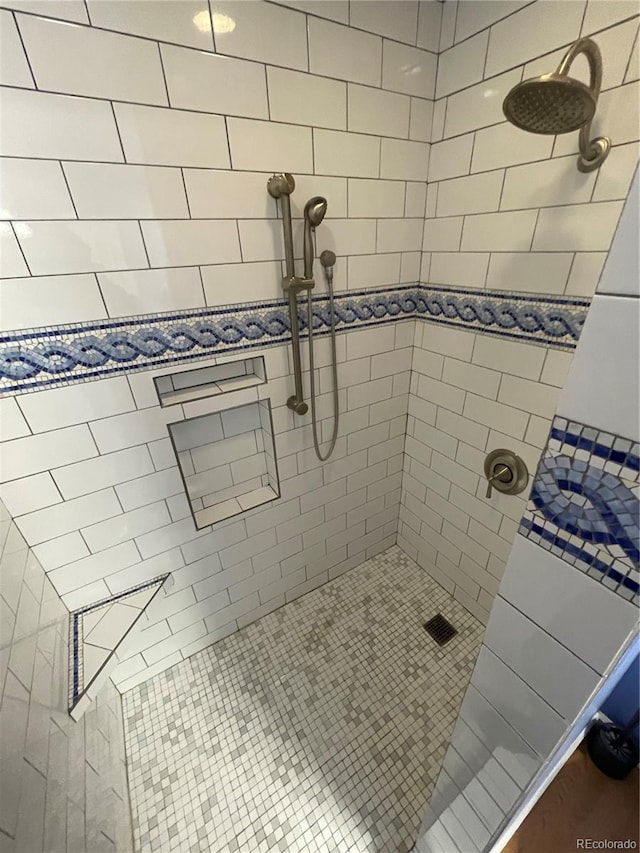 bathroom with a tile shower