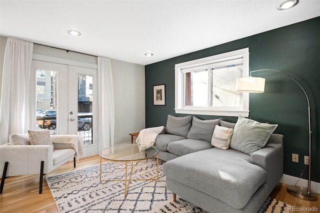 living area featuring wood finished floors, recessed lighting, french doors, and baseboards