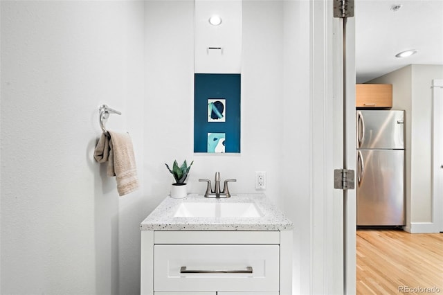 bathroom with vanity and wood finished floors