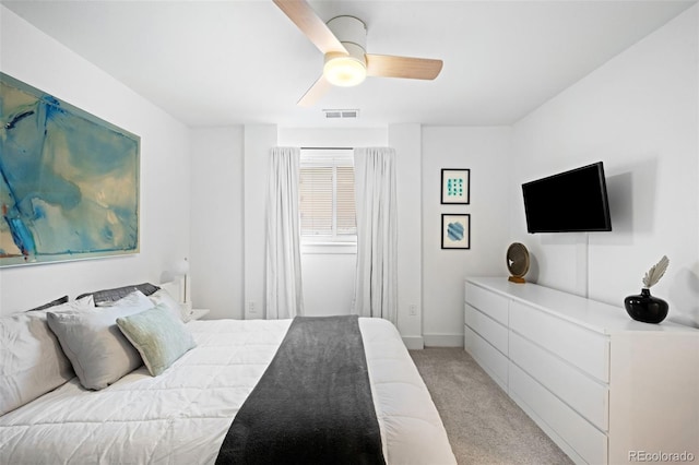 bedroom with visible vents, light carpet, and a ceiling fan