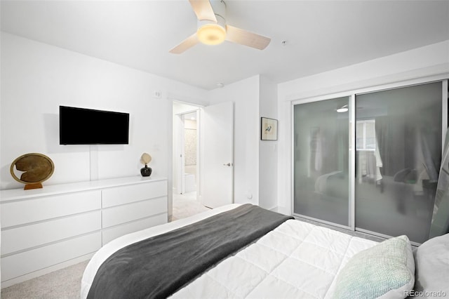 bedroom with ceiling fan, light colored carpet, and a closet