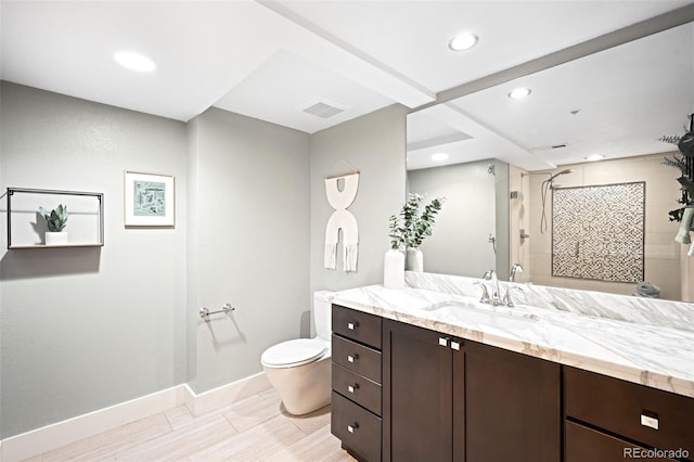 bathroom featuring vanity, visible vents, baseboards, a stall shower, and toilet