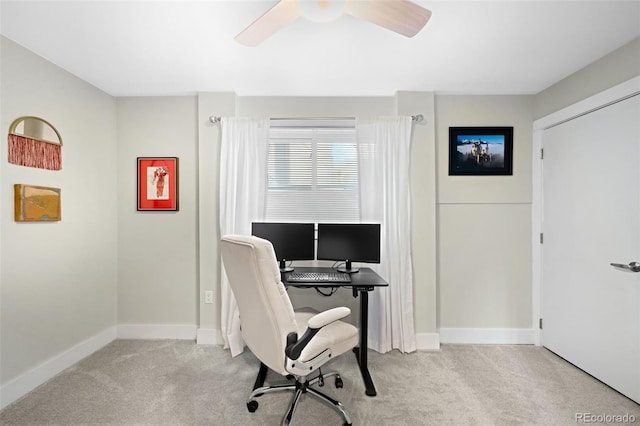 office space featuring ceiling fan and light colored carpet