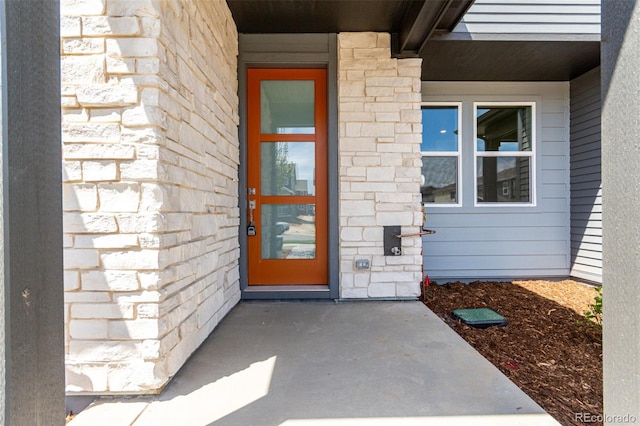 view of exterior entry with stone siding