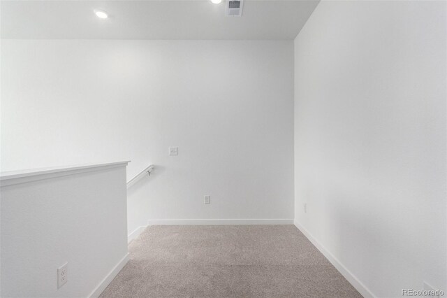 spare room with carpet flooring, baseboards, and recessed lighting