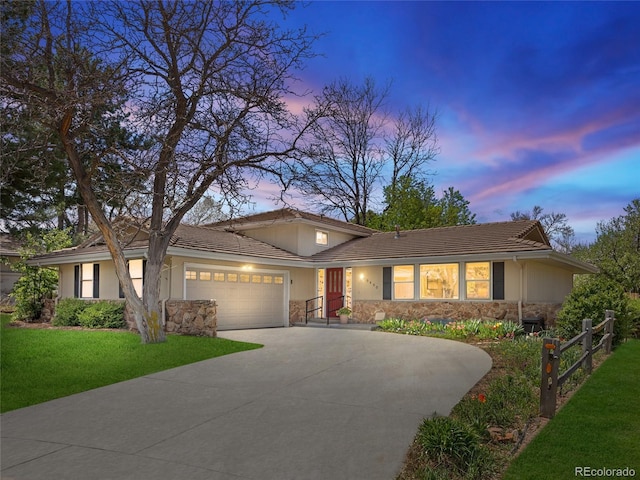 6490 S Pontiac Ct, Centennial, CO 80111 - view of front of property with an attached garage, a tile roof, stone siding, concrete driveway, and a yard