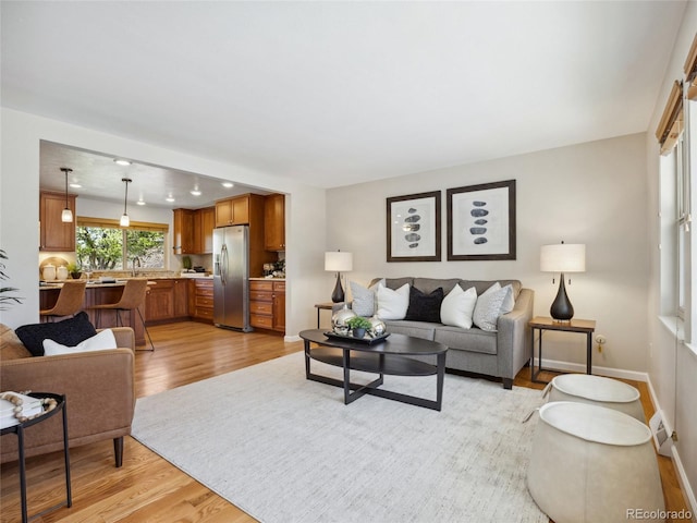 6490 S Pontiac Ct, Centennial, CO 80111 - living room featuring baseboards and light wood-type flooring
