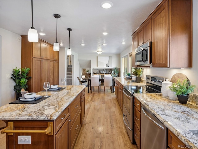 6490 S Pontiac Ct, Centennial, CO 80111 - kitchen with brown cabinets, appliances with stainless steel finishes, and light wood finished floors