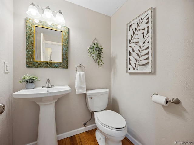 6490 S Pontiac Ct, Centennial, CO 80111 - bathroom featuring baseboards, wood finished floors, and toilet