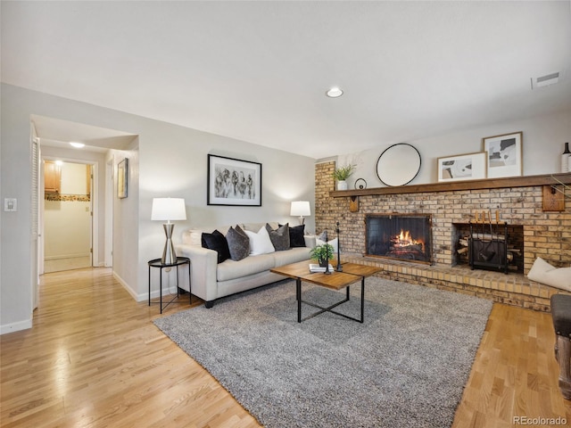 6490 S Pontiac Ct, Centennial, CO 80111 - living area with baseboards, wood finished floors, visible vents, and a fireplace