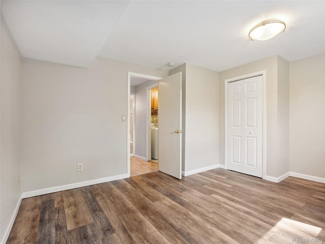 6490 S Pontiac Ct, Centennial, CO 80111 - unfurnished bedroom with baseboards, wood finished floors, and a closet