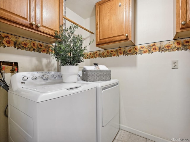 6490 S Pontiac Ct, Centennial, CO 80111 - clothes washing area with cabinet space, light tile patterned floors, and washer and dryer