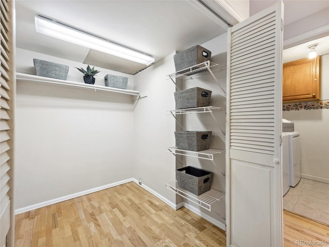6490 S Pontiac Ct, Centennial, CO 80111 - spacious closet featuring light wood-type flooring and washer and dryer