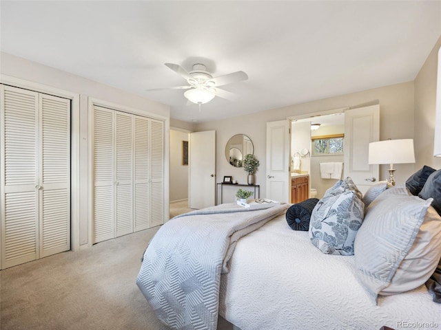6490 S Pontiac Ct, Centennial, CO 80111 - bedroom with connected bathroom, a ceiling fan, multiple closets, and light colored carpet