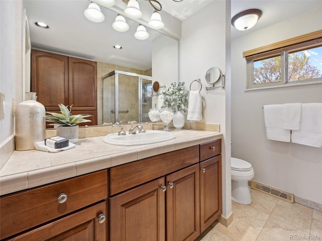 6490 S Pontiac Ct, Centennial, CO 80111 - bathroom featuring visible vents, a stall shower, vanity, baseboards, and toilet