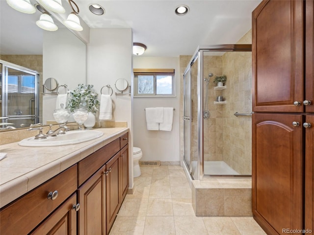 6490 S Pontiac Ct, Centennial, CO 80111 - bathroom featuring visible vents, a shower stall, vanity, tile patterned floors, and baseboards