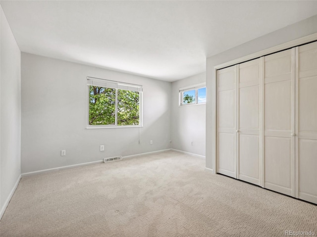 6490 S Pontiac Ct, Centennial, CO 80111 - unfurnished bedroom with a closet, baseboards, carpet flooring, and visible vents