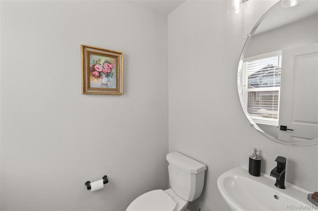 bathroom with toilet and sink