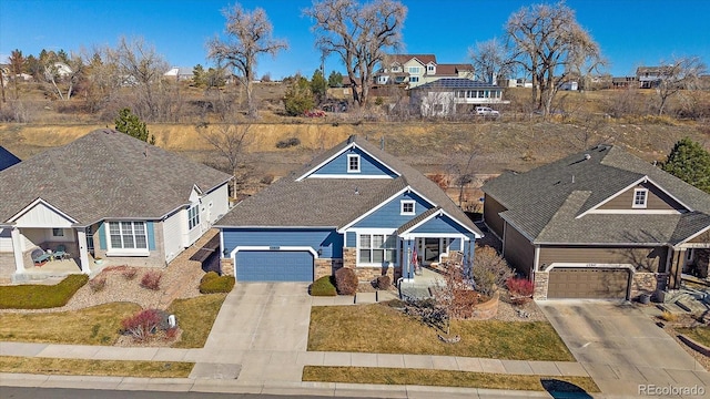 view of front of home with stone siding and concrete driveway