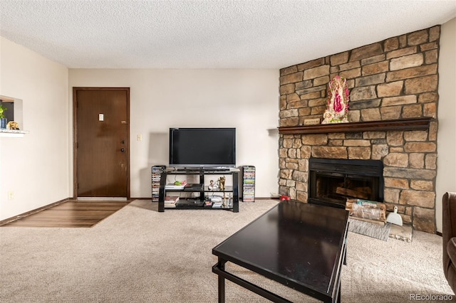 living room featuring carpet flooring, a fireplace, and a textured ceiling