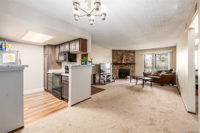 kitchen featuring a fireplace, a textured ceiling, light colored carpet, and black electric range oven